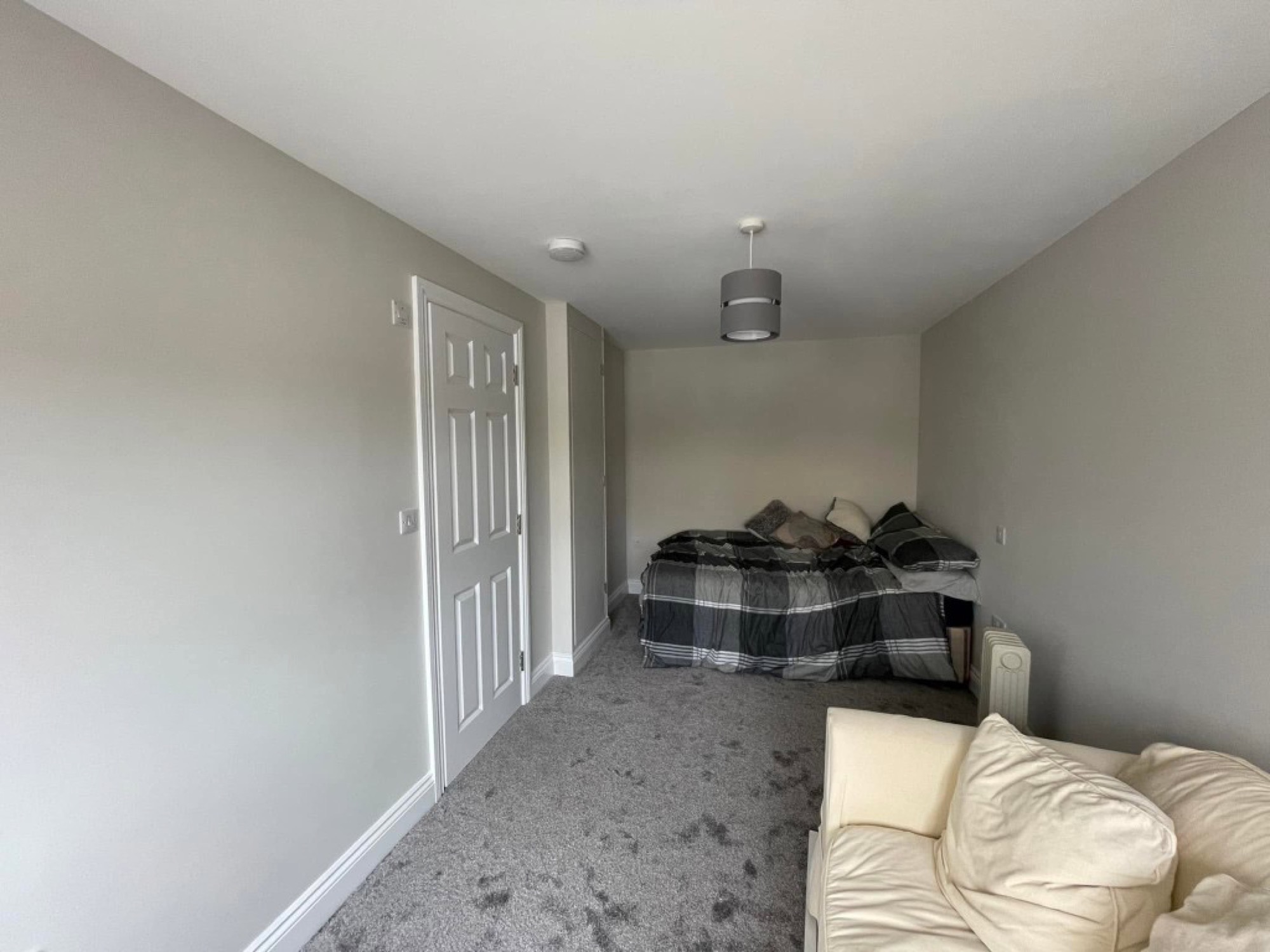 Garage conversion — finished interior with carpet and décor