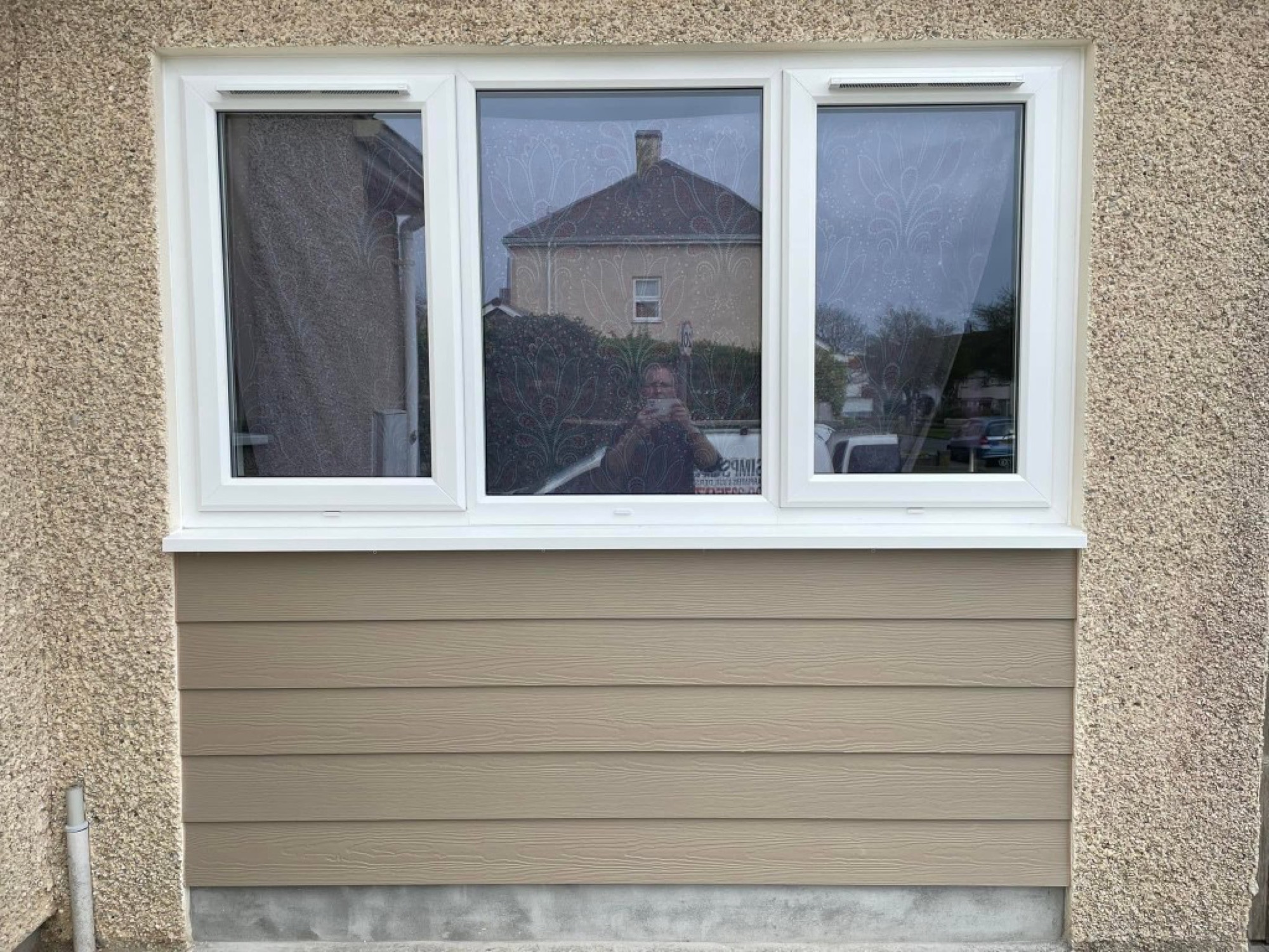 Garage conversion — finished exterior with new window and cladding
